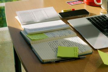 A desk with notes and papers on it 