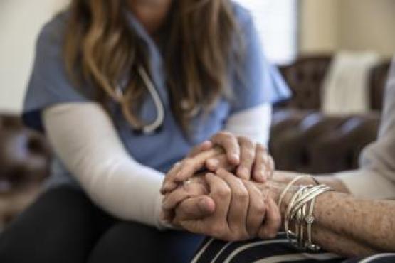 a nurse holding hands with patient