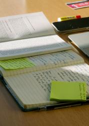 A desk with notes and papers on it 