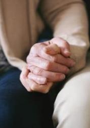 an elderly couple holding hands 